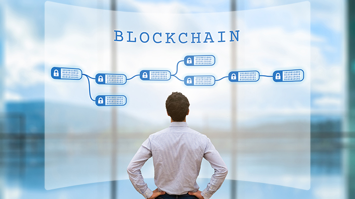 Person looking at blockchain concept on screen as a secured decentralized ledger for cryptocurrency financial technology and business transaction data, fintech